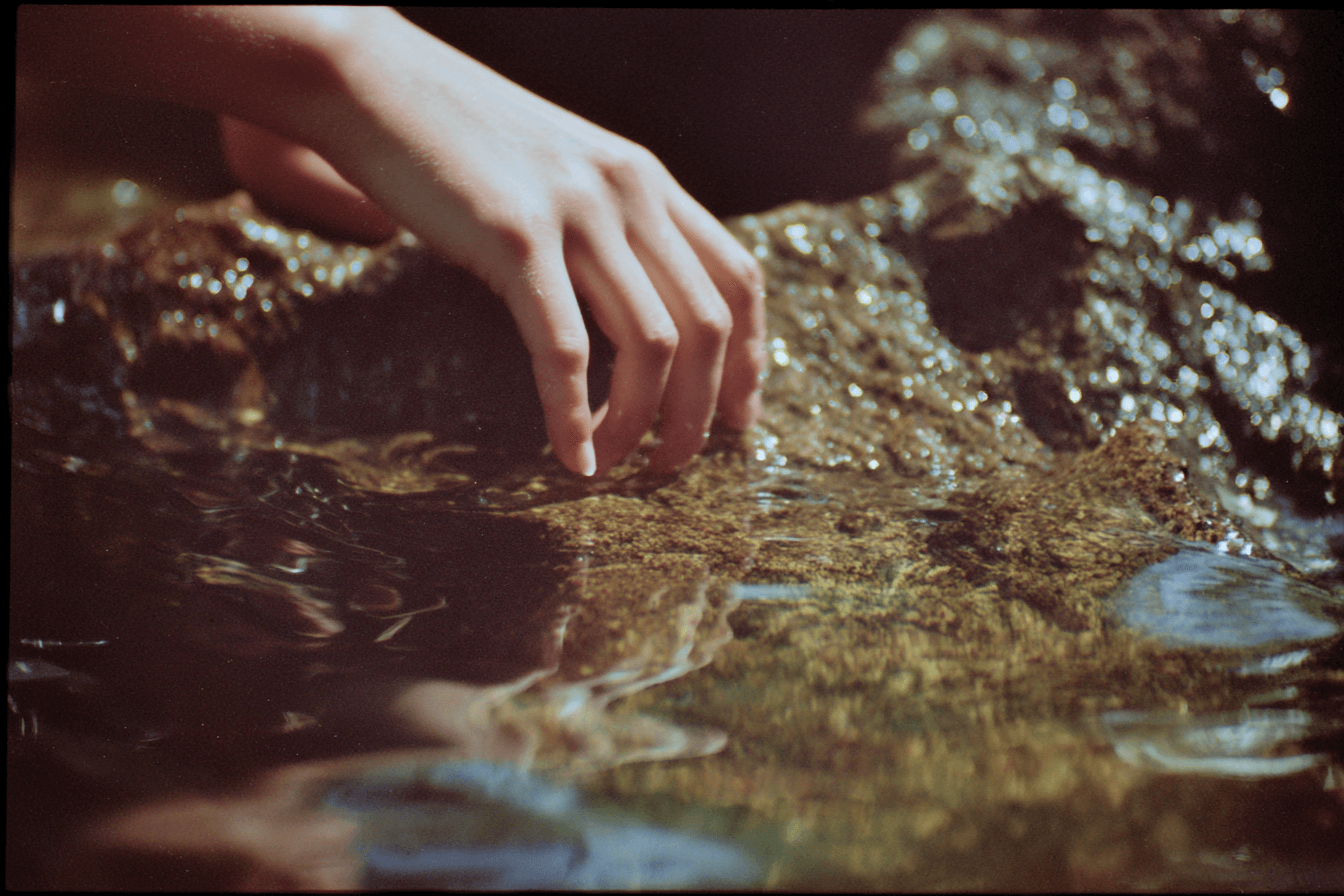 Hand touching water