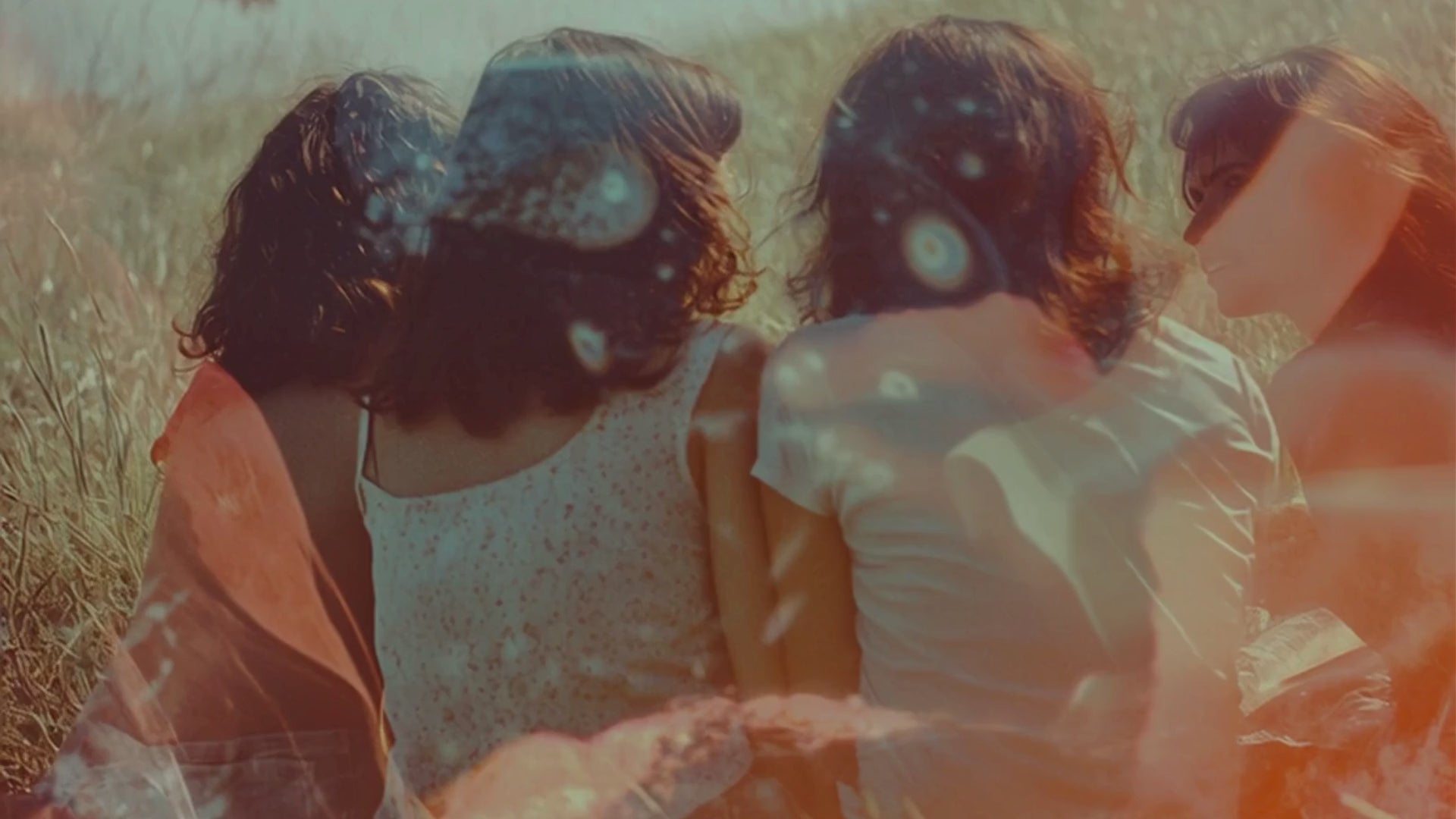 A group of women is sitting in the grass